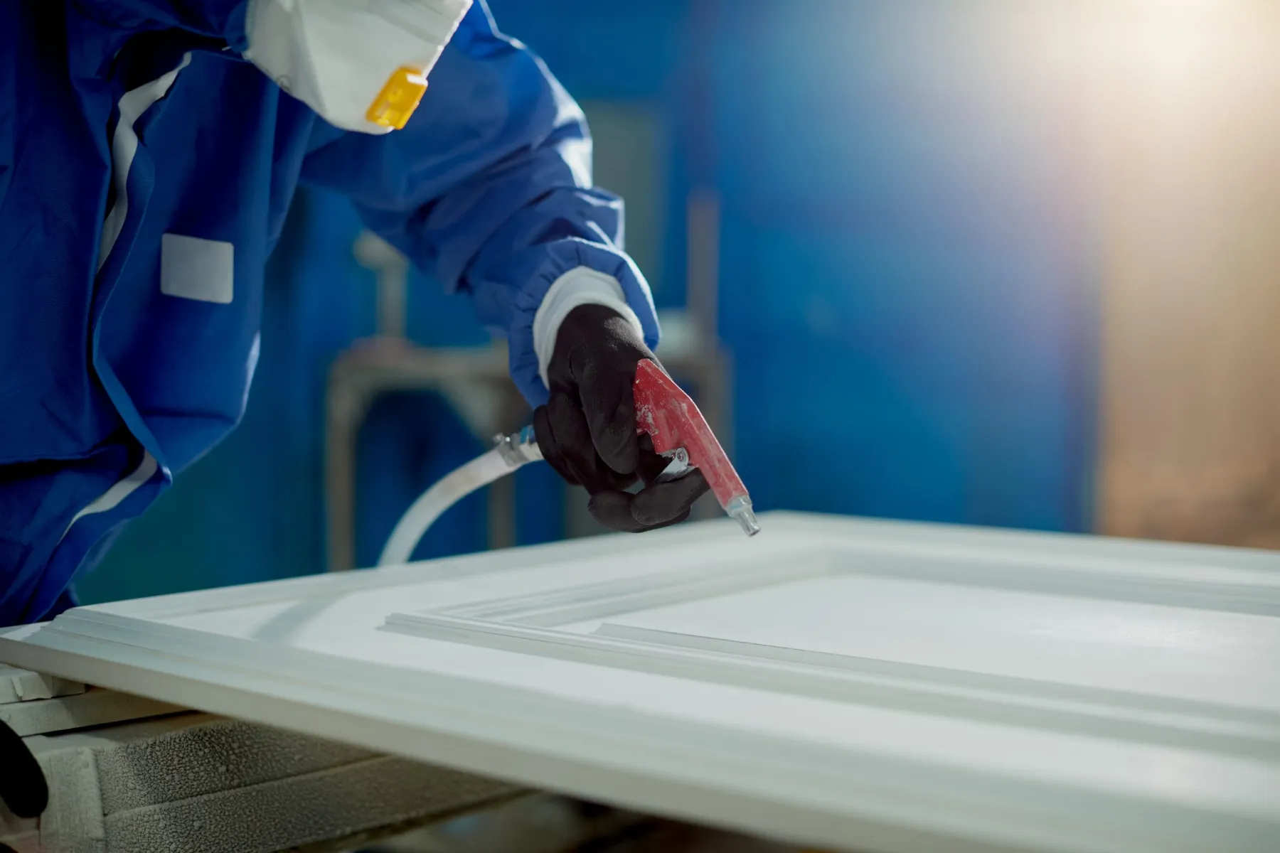 Spray finishing timber in the workshop
