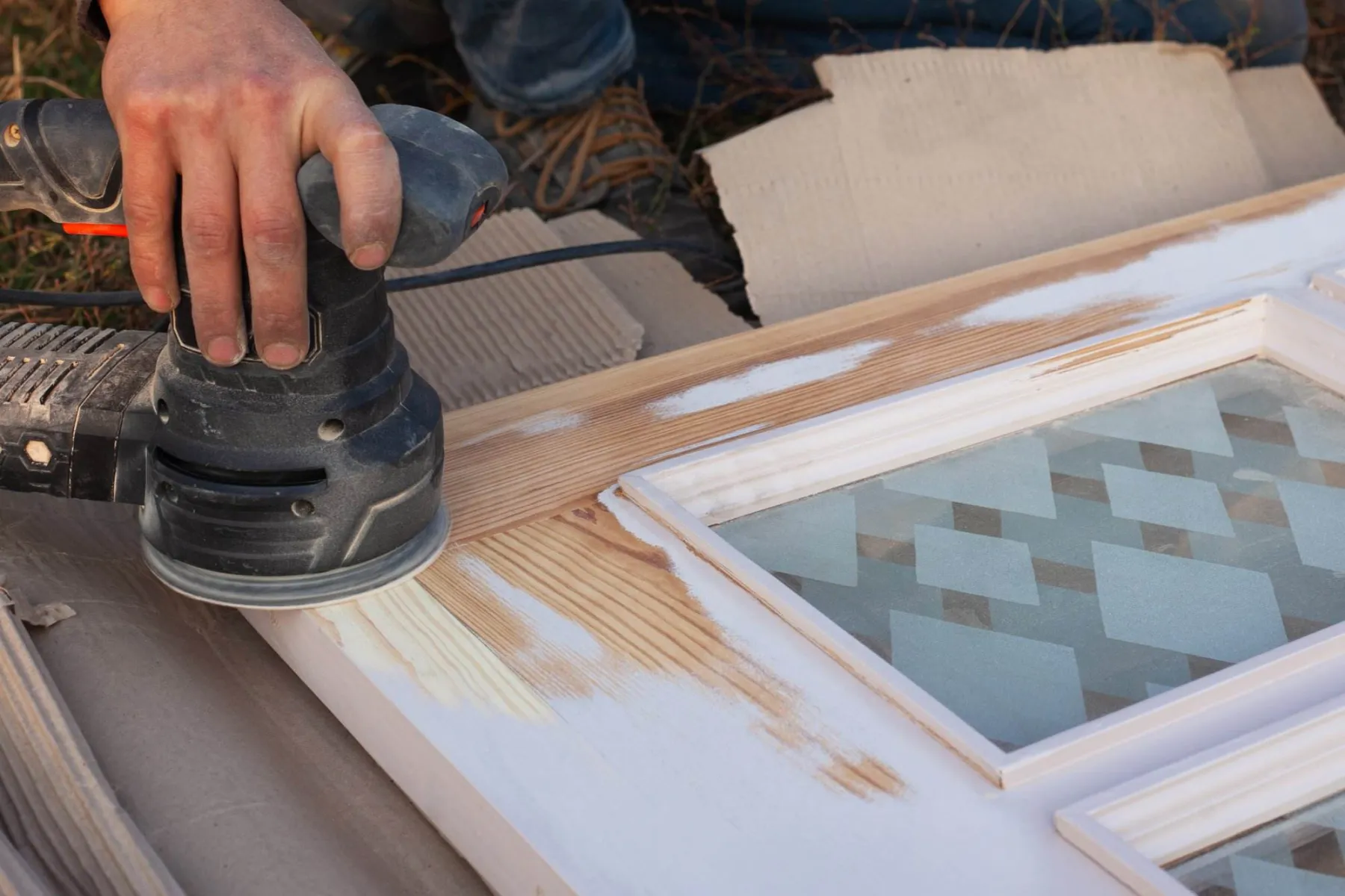 Sanding a door panel before finishing